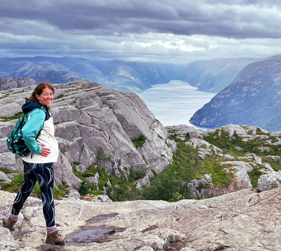 Me, Sally, the person behind Challenge Fifty Two. A white woman standing on top of a mountain. 